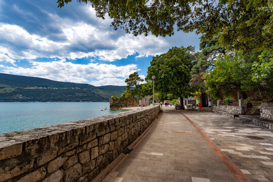 Seaside promenade of Herceg Novi curving beautifully along the deep blue waters of the Bay of Kotor, Montenegro