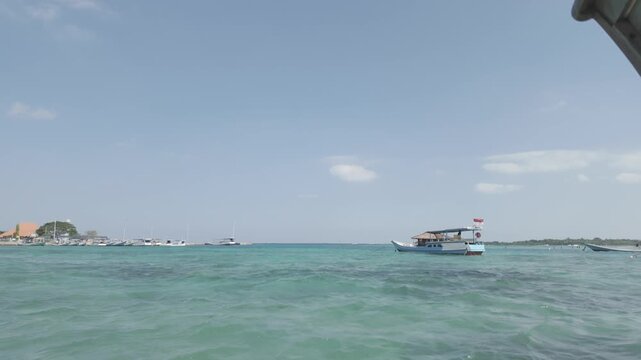 Boats Moored in Crystal Clear Blue Water at Karimunjawa Island, Indonesia