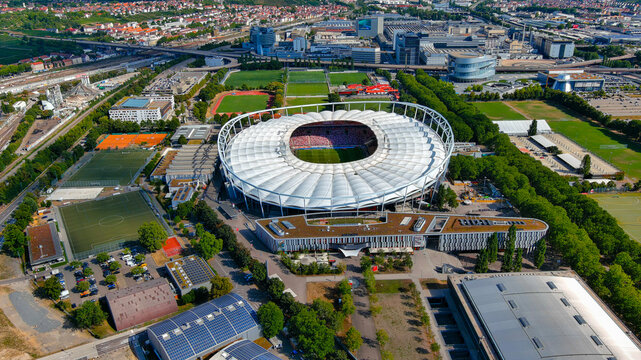 Aerial drone view of Mercedes-Benz Arena with crowd during VfB Stuttgart match, surrounded by Cannstatter Wasen sports complex, Stuttgart, Germany