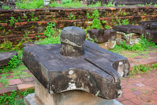 Ancient stone linga displayed among the archaeological remains of My Son Sanctuary in Vietnam.
