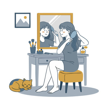 Woman brushing her hair in front of mirror at dressing table with sleeping cat