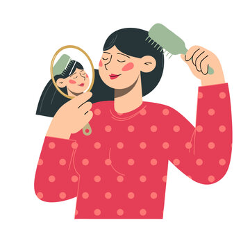 Woman brushing her hair while looking in hand mirror