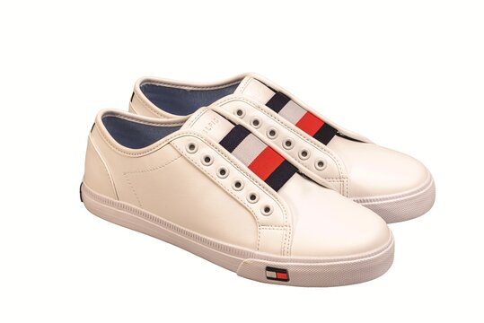 Close up view of Tommy Hilfiger white casual sneakers isolated on white background. Sweden. 