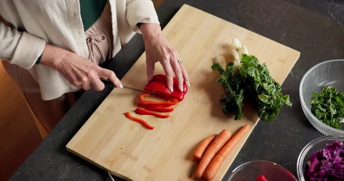 Above, hands and vegetables with person in kitchen of home for healthy meal preparation. Cooking, food and knife with senior woman at counter in apartment for cuisine, culinary hobby or recipe