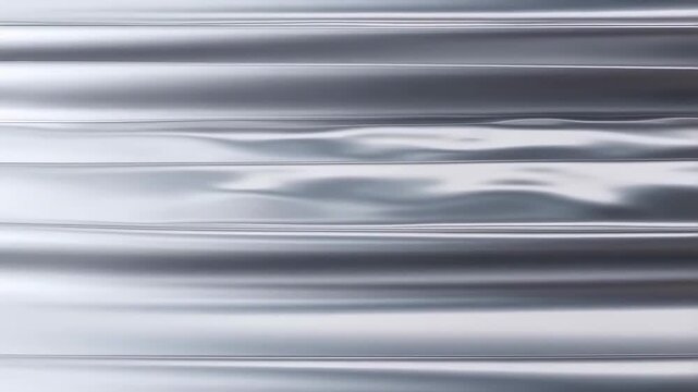 Slow pan tracking shot of water surface rippling and reflecting metallic light across calm coastal sea and lake shoreline at morning close up