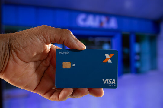 S&atilde;o Paulo, Brazil - June 12, 2026: hand holding Caixa Visa card in focus.