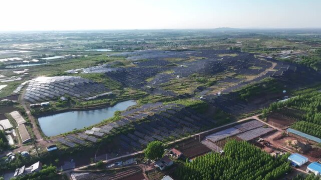 Aerial view of photovoltaic power station integrated with farmland and wetland landscape