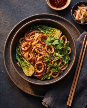 Spicy squid udon noodles with bok choy cilantro sesame and chili oil