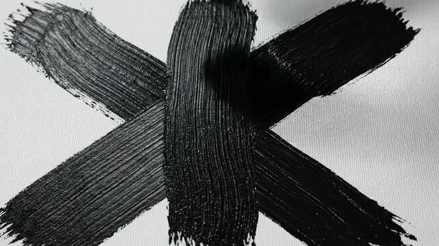 Artist Hand Painting Black Cross Stroke on White Canvas