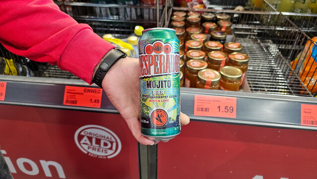 Hand holding desperados mojito beer can in aldi supermarket