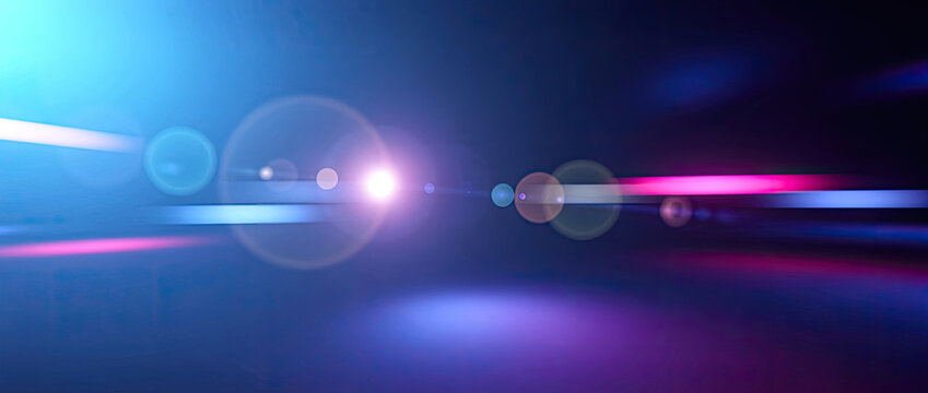 Abstract Blue and Pink Light Streaks with Lens Flares on Dark Background.