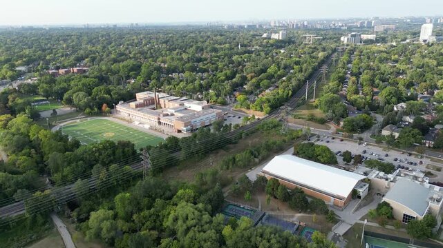 Aerial passing north of Bloor Street West in the Kingsway area of Toronto, Ontario, Canada. Northeast towards the York skyline, and over the subway tracks between Royal York and Islington.
