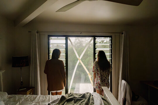 UGC Sisters looking out window during cyclone in Northern Rivers