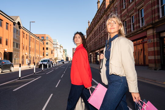 Best Friends Crossing Street Holding Shopping Bags