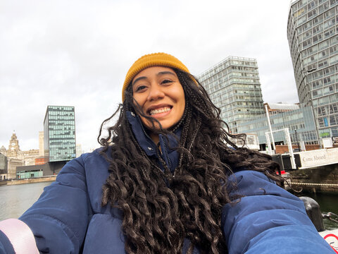 Woman Smiles While Taking Selfie in Liverpool, UK