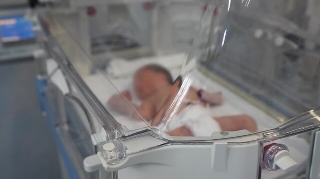 Newborn Baby in an Incubator With Medical Equipment.Empty infant incubator in an hospital room. Specially equipped room with newborn babys sleeping in incubators in the Obstetrics and Gynecology Hospi