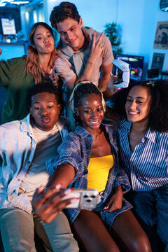 Friends taking selfie during fun gaming night together