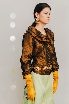 Retro editorial portrait with bronze satin and floral earrings