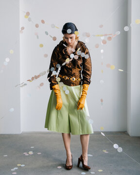 Full length editorial fashion portrait with pastel garlands