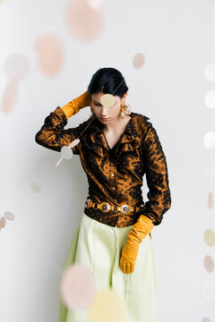 Retro editorial portrait with satin polka dots and opera gloves