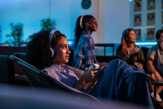 Gaming night with friends in a blue-lit room.