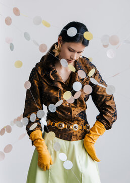 Editorial fashion portrait with satin textures and pastel garlands