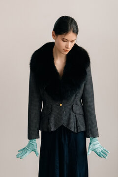 Elegant portrait in tailored jacket with dramatic fur collar