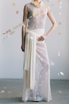 Close up of sheer embroidered dress with draped fabric detail