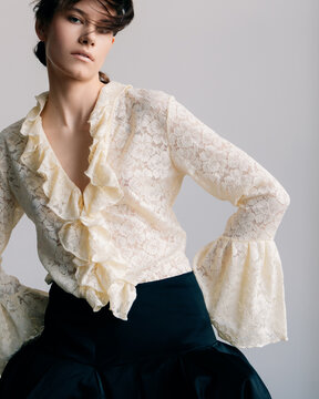 Editorial close-up with floral lace and dramatic ruffles