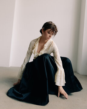 Moody editorial portrait with lace textures and dark volume
