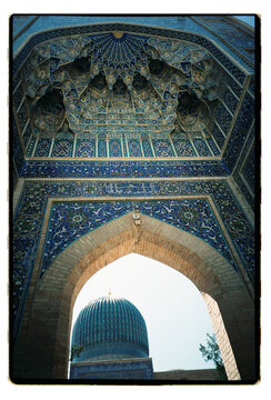 Intricate tilework in archway of historic Uzbekistan mosque