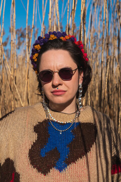 Close up portrait of woman with sunglasses in dry reeds