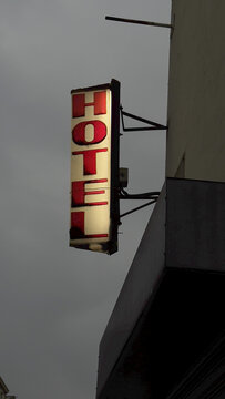 Bright hotel sign on a cloudy day in the city