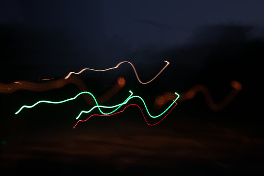 Abstract, colourful light patterns of moving cars shot at night 