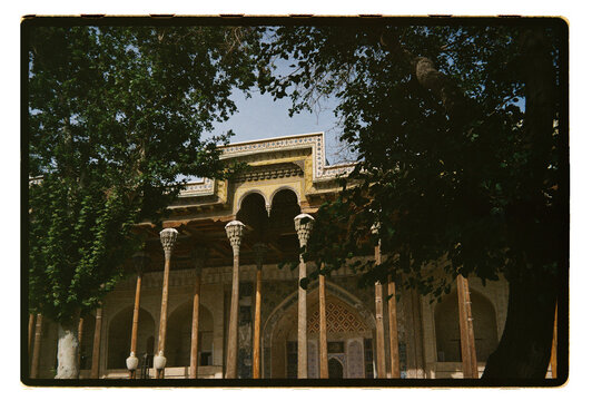 Ornate palace framed by trees in Uzbekistan