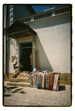 Embroidered textiles displayed outside a doorway in Bukhara