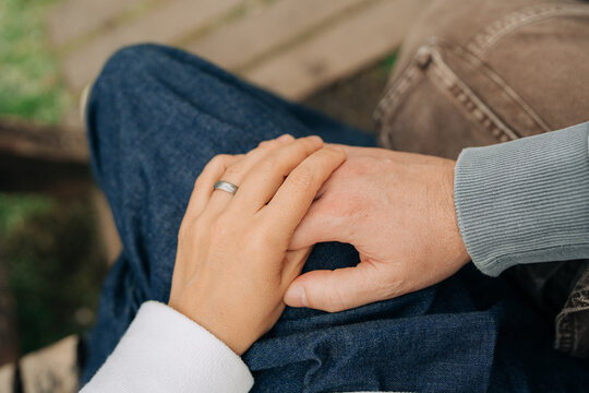 Close Up of Couple Holding Hands Outdoors in Romantic Relationsh