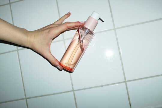 Pink beauty cosmetic product pump bottle with hard direct flashlight