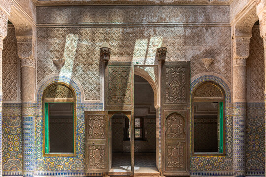 Intricate Moorish courtyard wall with carved wood and mosaic tile 