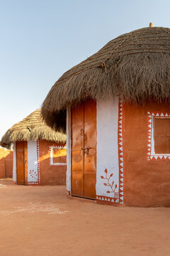 Traditional mud huts with thatched roofs in rural village