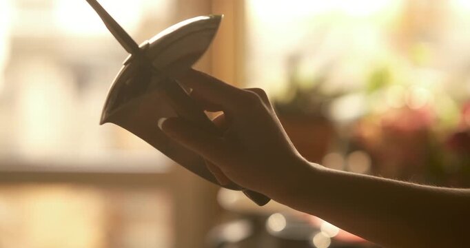 Cinematic Close-Up of Fencer Hand Holding Sword with Bell Guard in Warm Golden Light. a fencer's hand gripping a fencing sword, highlighting the metallic bell guard and blade. Bathed in warm, golden 