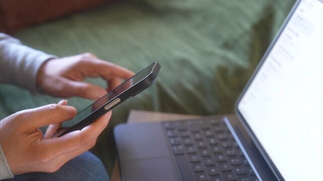 Person using digital devices to review financial information and manage transactions. AI finance, financial technology, smart analytics, automation and digital investment concept.