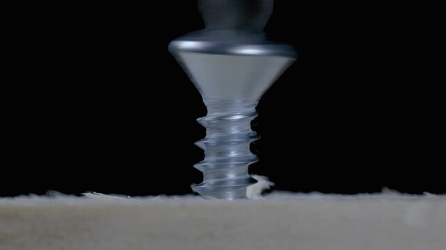 Slow Motion Macro Screwdriver Driving Countersunk Screw Into Wood
