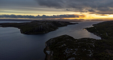 Obraz premium drone shot of midnight sun over Bokfjord near Ropelv in South Varanger, Northern Norway