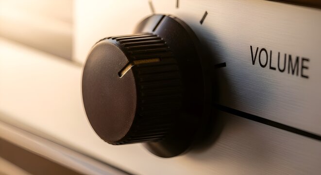 Close-up of a volume knob controlling audio level on a metallic device