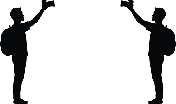 Minimalist solid black glyph icon illustration of two backpacker photographers standing face to face holding up cameras to take pictures on white background