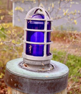 A close view of the blue light on a pole.
