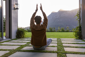Obraz premium Concrete pavers are forming patio with grass strips leading to sunlit mountains at sunset