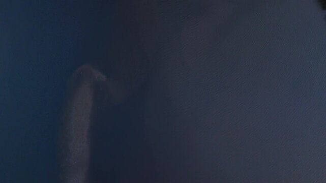 Aerial view captures a dark blue lake. Ideal for environmental projects.