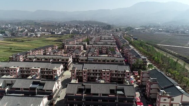 Aerial view of rural town with farmland and mountains